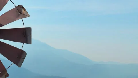 Close-up of a small windmill spinning in the wind Stock Footage 327045164