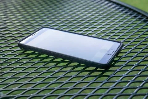 Close up of smart cellphone with flat screen, modern technology outside. Stock-Fotos