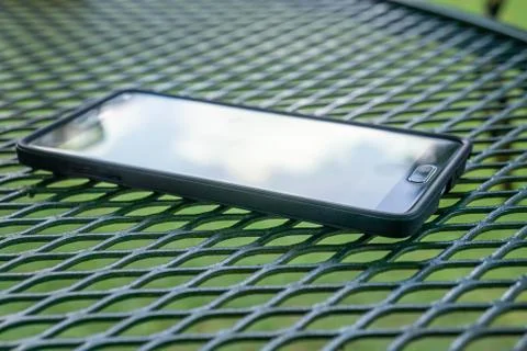 Close up of smart cellphone with flat screen, modern technology outside. Stock Photos
