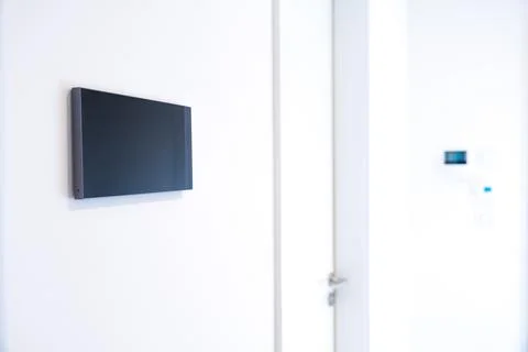 Close-up of a smart home control panel mounted on a white wall in a modern Stock Photos