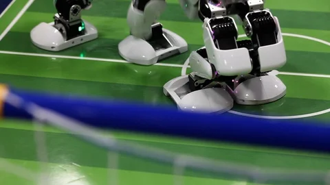 Close up of smart humanoid robot foot warming up on football field Video stock 106672424