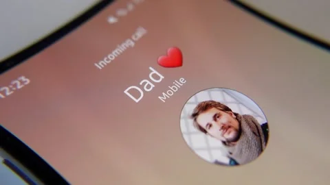 Close-up of the smart phone screen and an incoming call from dad with picture Stock Footage 169836550