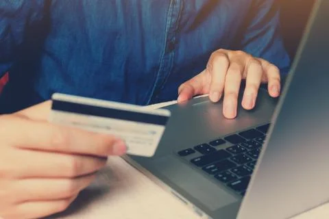Close up smart young man typing trackpad on laptop with shopping online or in Stock Photos