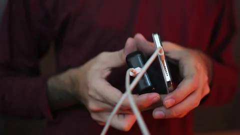 Close Up of Smartphone Charging with USB Cable and Power Adapter in Hand Stock Footage 337847452