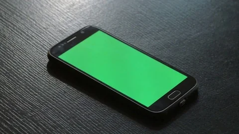 Close-up of smartphone with chroma key green screen on black table. Stock Footage 80472653