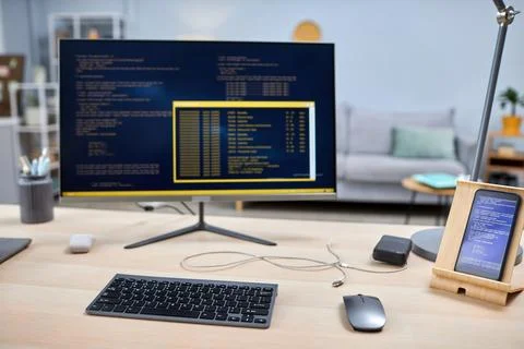 Close up of smartphone with code lines on IT developers workplace 库存照片