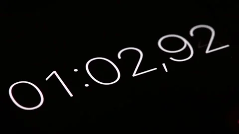Close-up of smartphone digital stopwatch with white numbers and black background Stock Footage 223341177