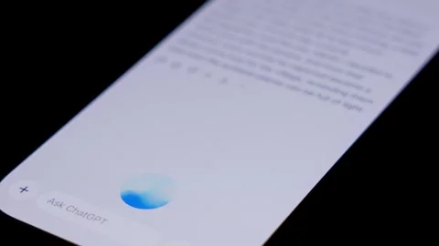 Close-up of smartphone displaying AI assistant app interface, with ChatGPT 스톡 동영상 333928551