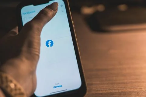 Close-up of a smartphone displaying the Facebook app login screen with the .. Stock Photos