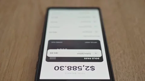 Close-up of a smartphone displaying a mobile banking application 스톡 동영상 337998092