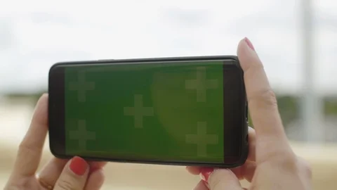 Close-up of smartphone with Green Screen at Eiffel Tower, holding by woman in Stock Footage 111926353