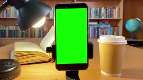 Close up of smartphone with green screen in library. Stock Footage 177464101