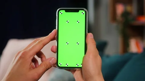 Close-up of smartphone with green screen, young man hands holding mobile phone Stock Footage 155120401