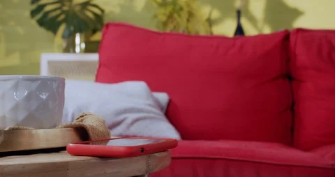 Close-up smartphone with incoming call screen on coffee table. Young curious Stock Footage 120209124
