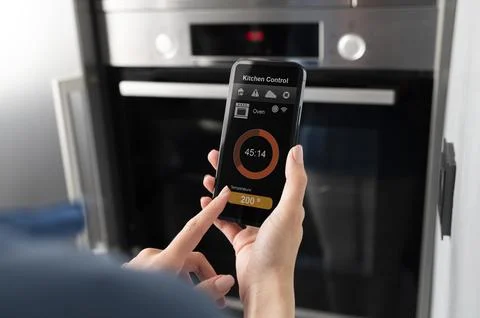 Close up smartphone with kitchen control Stock Photos