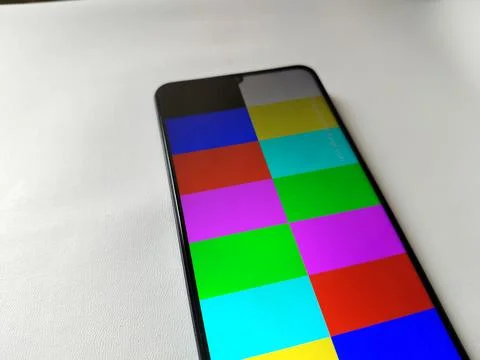 Close-up of a smartphone LCD display featuring a mix of bright and varied colors Foto stock