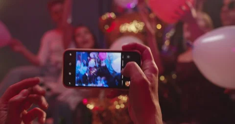 Close up of the smartphone in male hand while he taking photos of his young Stock Footage 122511623
