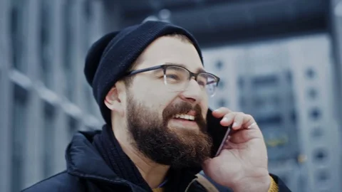 Close up smartphone man talking on phone, smiling in front of business center Stock-Footage 71981849