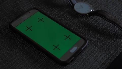 Close Up of smartphone mock-up green screen lying on a table in apartment near a Stock Footage 110772237