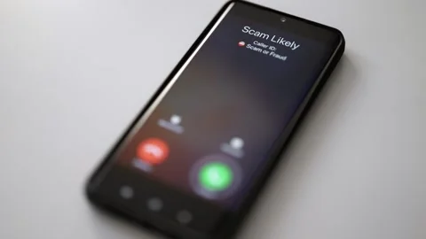 Close-up of smartphone screen displaying dangerous incoming scam call. Stock Footage 338999143