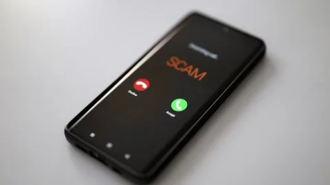 Close-up of smartphone screen displaying dangerous incoming scam call. Stock Footage 338999167