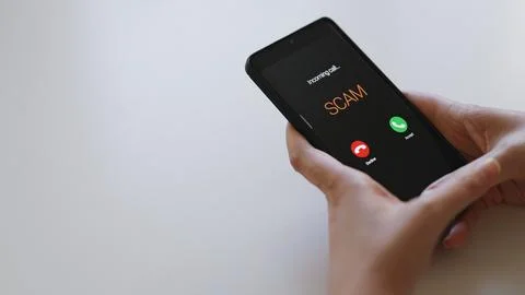 Close-up of smartphone screen displaying dangerous incoming scam call. Stock Photos