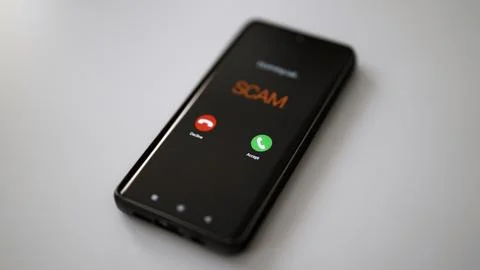 Close-up of smartphone screen displaying dangerous incoming scam call. Stock Photos