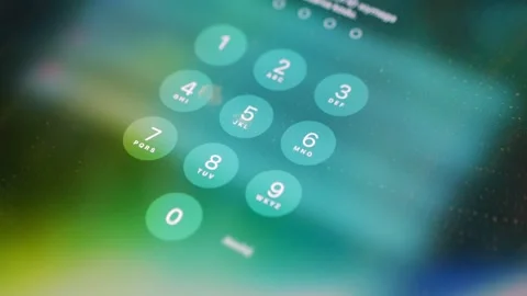 Close-up of a smartphone screen displaying a numeric keypad for entering a .. Stock Footage 293090783