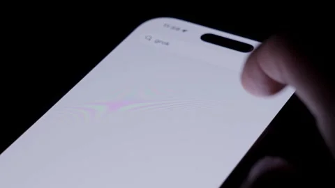 Close up of smartphone screen downloading Grok from App Store, showing modern Stock Footage 334059862