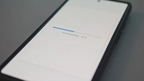 Close up of smartphone screen with file download percentage indicator concept Stock Footage 341569713
