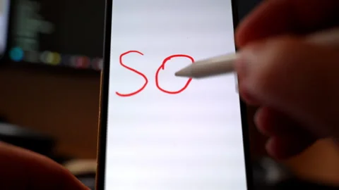 Close-up of a smartphone screen as a hand writes SQL in red digital ink using Stock Footage 330612602