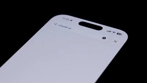Close-up of smartphone screen searching for Claude AI app in app store, with Stock Footage 333928535