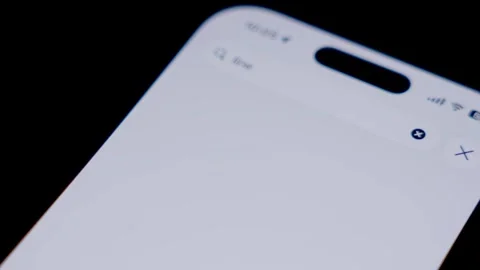 Close-up of a smartphone screen showing the LINE app being searched and Stock Footage 337240608