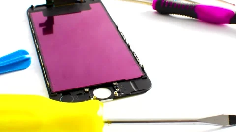 Close-up of a smartphone under maintenance, showcasing tools on a clear sur.. Stock Footage 260821467