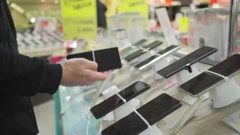 Close-up of smartphones on display in a tech store Stock Footage 305974741