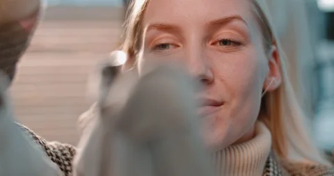 Close up of the smiled happy face of young blond woman looking at the clothes Stock Footage 122517518
