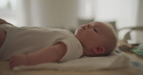 Close-Up of Smiling Baby Boy on Changing Table Stock Footage 318001065