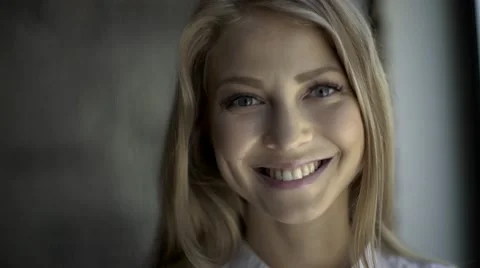 Close up Of A Smiling blond woman with natural makeup wearing white shirt Stock Footage