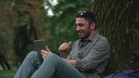 Close-up of smiling caucasian freelancer talking via tablet video Stock Footage 186559230