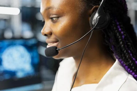 Close up of smiling data center worker providing user technical support Stock Photos