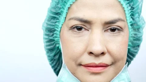 Close-up, smiling doctor looking at camera wearing face mask properly Stock Footage 244216046