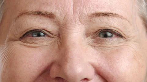 Close-Up of a Smiling Elderly Woman's Eyes, Highlighting the Beauty of Aging Stock Footage 270308968