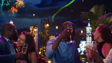 Close up of smiling friends toasting on New Year Eve and exchanging cheek kisses Stock Footage 346783591