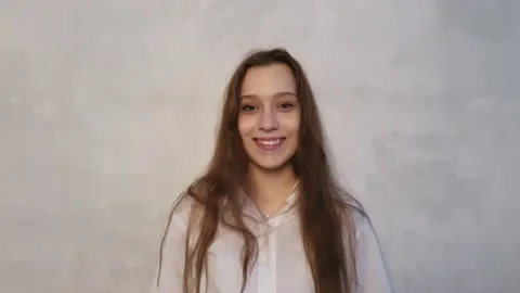 Close up of smiling girl looking at camera in studio. Curly hair fashion model Stock Footage 170733299