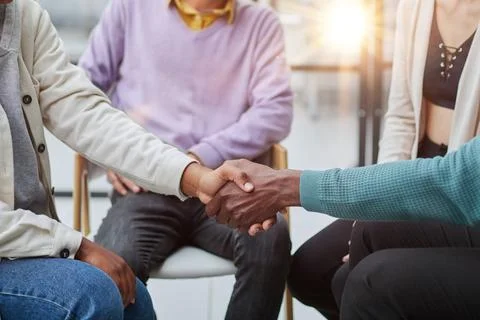 Close up. smiling guy shaking hands with his friend Stock Photos