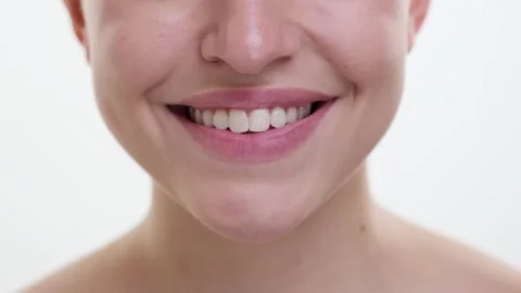 Close Up of Smiling Lips on White Background Stock Footage 254510411