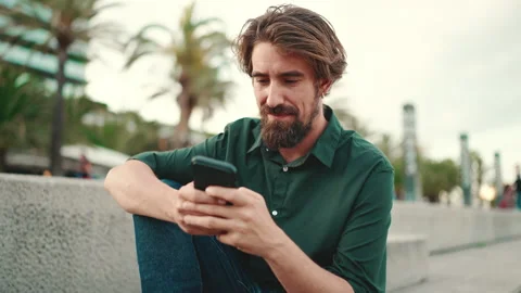 Close-up of smiling man with a beard chatting on the embankment background Stock Footage 226891475