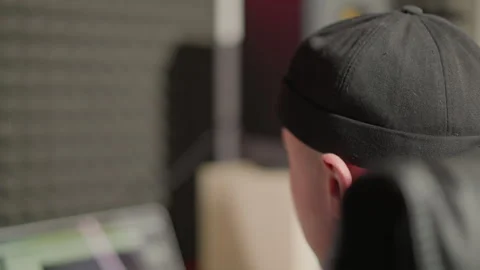 Close-Up of Smiling Man in Black Cap with Blurred Computer Screen in Front Stock Footage 283136276