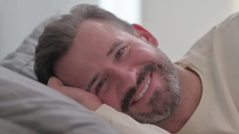 Close up of Smiling Man Looking at Camera in Bed Stock Footage 287899365