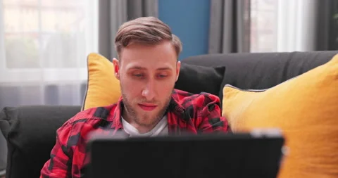 Close up smiling man using computer tablet, chatting online, making video call Stockbeeldmateriaal 154054211